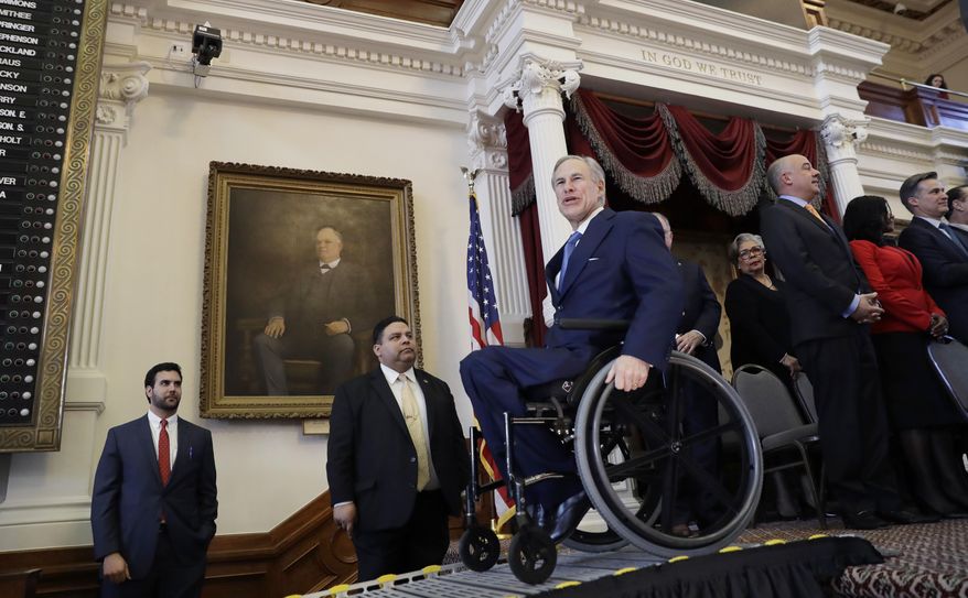 Texas Gov. Greg Abbott, center, uses a ramp to exit the House Chamber at the Texas State Capitol after he addressed the opening session of the 85th Texas Legislative session, Tuesday, Jan. 10, 2017, in Austin, Texas. (AP Photo/Eric Gay)