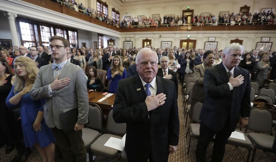 Sid Miller, agriculture commissioner, center, joins in the pledge during the opening of the 85th Texas Legislative session in the house chamber at the Texas State Capitol, Tuesday, Jan. 10, 2017, in Austin, Texas. (AP Photo/Eric Gay)