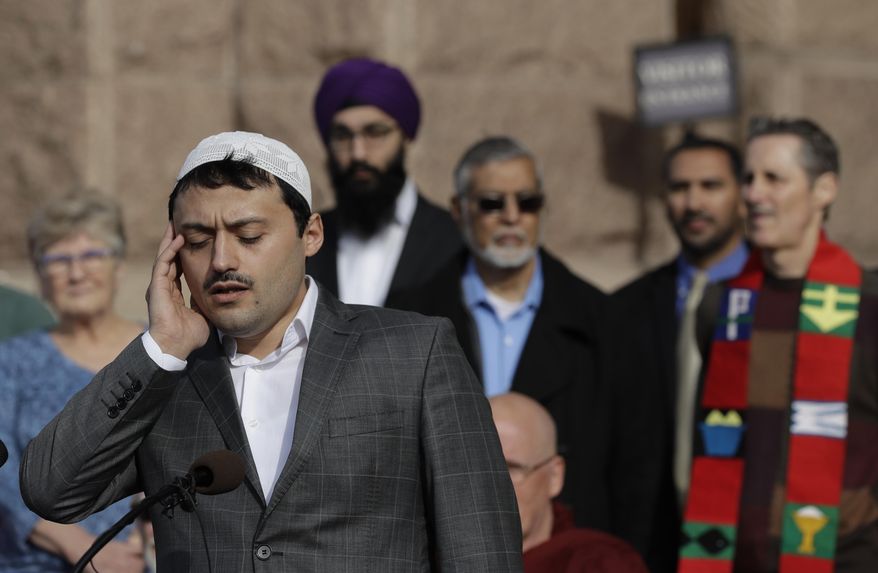 Okan Dogan of the Islamic Institute of Austin sings a prayer during an interfaith prayer event on the steps of the Texas State Capitol before the 85th Texas Legislative session begins, Tuesday, Jan. 10, 2017, in Austin, Texas. (AP Photo/Eric Gay)