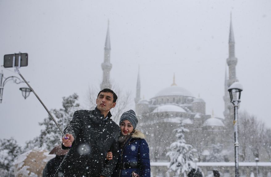 In this photo taken on Monday, Jan. 9, 2017, a couple takes a selfie at Sultanahmet district, one of Istanbul&#39;s main tourist attractions. TThese days, with a string of terror attacks targeting Istanbul still fresh in his memory, some residents say they are adapting their daily routines because of fears they could become the latest victims of violent extremism. (AP Photo/ Emrah Gurel)
