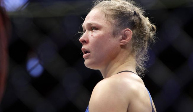 FILE - In this Dec. 30, 2016, file photo, Ronda Rousey stands in the cage after Amanda Nunes forced a stoppage in the first round of their women&#x27;s bantamweight championship mixed martial arts bout at UFC 207 in Las Vegas. Rousey broke her silence since the fight by posting a quote about rebuilding from &amp;quot;rock bottom&amp;quot; on Instagram Monday, Jan. 9, 2017. (AP Photo/John Locher, File)