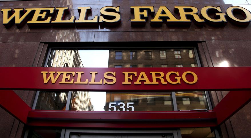 FILE - This May 6, 2012, file photo, shows a Wells Fargo sign at a branch in New York. Wells Fargo announced Tuesday, Jan. 10, 2017, it is completely restructuring how it pays tellers and other bank branch employees after a scandal over its aggressive sales practices. (AP Photo/CX Matiash, File)