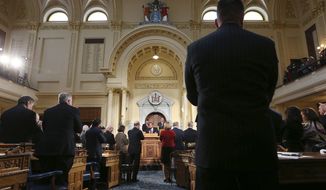 Members of the New Jersey legislature stand and applaud as New Jersey Gov. Chris Christie, center, stands in the Assembly chamber of the Statehouse as he delivers his State Of The State address Tuesday, Jan. 10, 2017, in Trenton, N.J. (AP Photo/Mel Evans)