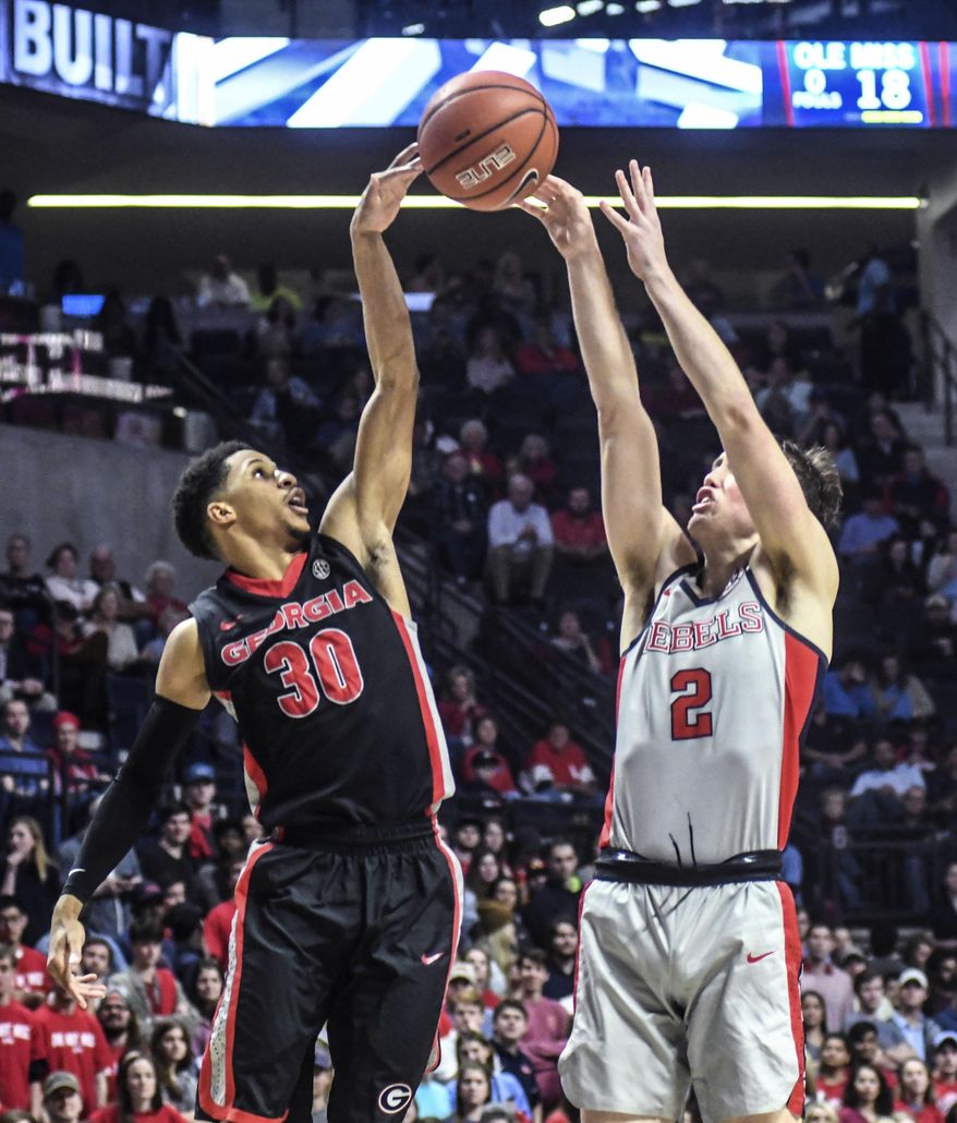 Georgia guard J.J. Frazier (30) blocks a shot by Mississippi guard Cullen Neal (2) during an NCAA college basketball game Wednesday, Jan. 11, 2017, in Oxford, Miss. (Bruce Newman/Oxford Eagle via AP)