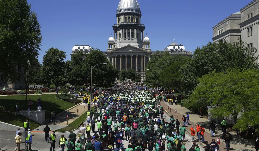 Union supporters rally against Republican Illinois Gov. Bruce Rauner&#x27;s calls to change collective bargaining policies, in front of the Illinois State Capitol Wednesday, May 18, 2016, in Springfield, Ill. The march is organized by a coalition of labor groups called Illinois Working Together. (AP Photo/Seth Perlman)