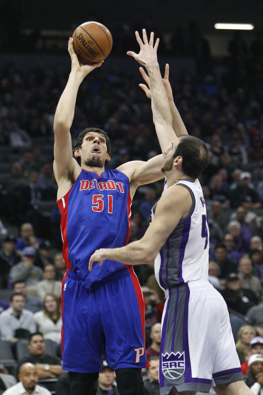 Detroit Pistons center Boban Marjanovic (51) shoots over Sacramento Kings defender Kosta Koufos (41) during the first half of an NBA basketball game in Sacramento, Calif., Tuesday, Jan. 10, 2017. (AP Photo/Steve Yeater)