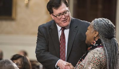 Rep. Jay Lucas, R-Darlington, left, shakes hands with a woman before the state of the state address in the House chambers at the sate Capitol, Wednesday, Jan. 11, 2017, in Columbia, S.C. (AP Photo/Sean Rayford)