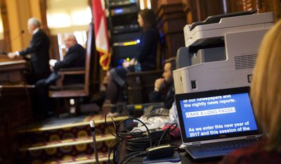 A computer monitor displays the speech of Georgia Gov. Nathan Deal, left, as he delivers the State of the State address on the House floor in Atlanta, Wednesday, Jan. 11, 2017. Deal is asking Georgia lawmakers to support a new plan for fixing low-performing schools after voters last fall rejected a proposal for state takeovers of schools that consistently struggle. The Republican governor said in his State of the State speech Wednesday that nearly 89,000 students were stuck in failing schools last year and their number &amp;quot;will grow with each passing school year&amp;quot; if nothing is done. (AP Photo/David Goldman)