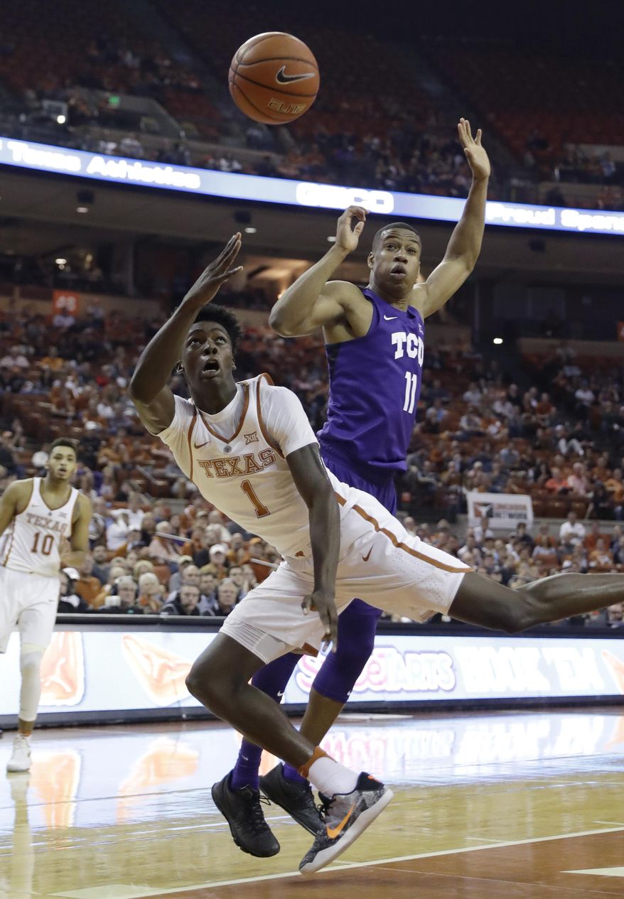 Texas guard Andrew Jones (1) shoots past TCU guard Brandon Parrish (11) during the second half of an NCAA college basketball game, Wednesday, Jan. 11, 2017, in Austin, Texas. TCU won 64-61.(AP Photo/Eric Gay)