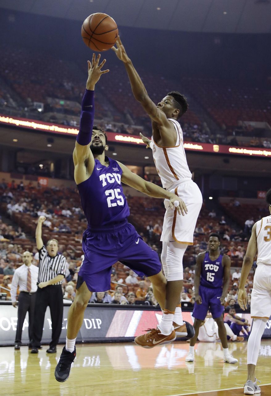 TCU guard Alex Robinson (25) is fouled by Texas guard Kerwin Roach Jr. (12) as he shoots during the first half of an NCAA college basketball game, Wednesday, Jan. 11, 2017, in Austin, Texas. (AP Photo/Eric Gay)