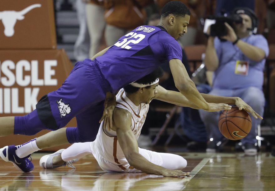 TCU forward Karviar Shepherd (32) and Texas forward Jarrett Allen (31) chase a loose ball during the first half of an NCAA college basketball game, Wednesday, Jan. 11, 2017, in Austin, Texas. (AP Photo/Eric Gay)