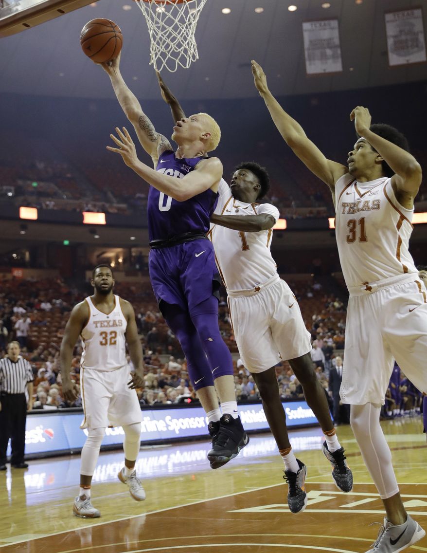 TCU guard Jaylen Fisher (0) scores past Texas defenders Andrew Jones (1) and Jarrett Allen (31) during the first half of an NCAA college basketball game, Wednesday, Jan. 11, 2017, in Austin, Texas. (AP Photo/Eric Gay)