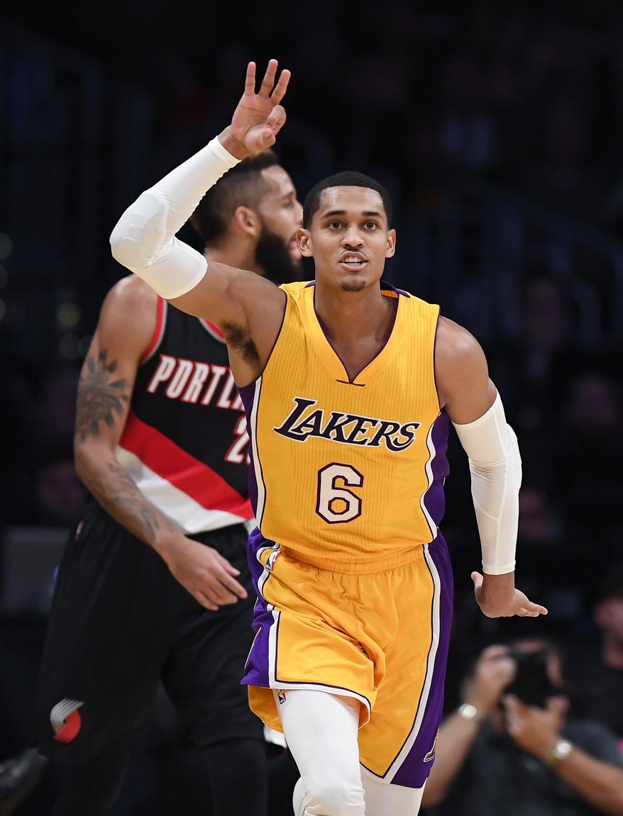 Los Angeles Lakers guard Jordan Clarkson, right, celebrates after hitting a 3-point shot as Portland Trail Blazers guard Allen Crabbe stands in the background during the first half of an NBA basketball game, Tuesday, Jan. 10, 2017, in Los Angeles. (AP Photo/Mark J. Terrill)