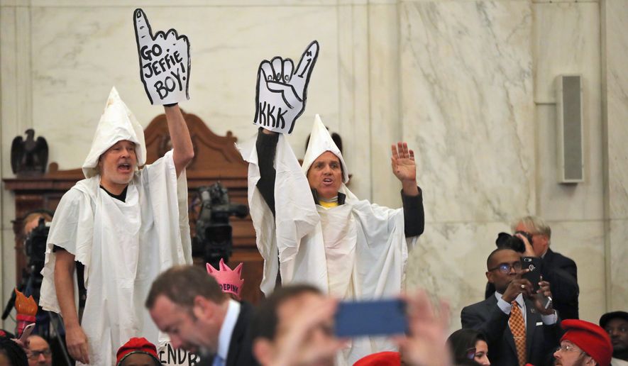 Protesters dressed as Ku Klux Klan members disrupt the Senate Judiciary Committee&#x27;s confirmation hearing for Attorney General-designate Sen. Jeff Sessions on Tuesday. (Associated Press)