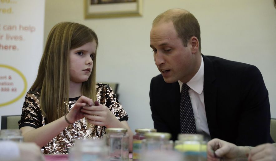 Britain's Prince William speaks with Aoife, 9, during his visit to a Child Bereavement UK Centre in Stratford in east London, Wednesday, Jan. 11, 2017. Prince William has been the royal patron of the Child Bereavement UK organisation since 2009. It supports families and educates professionals when a baby or child of any age dies or is dying, or when a child is facing bereavement. (AP Photo/Matt Dunham, Pool)