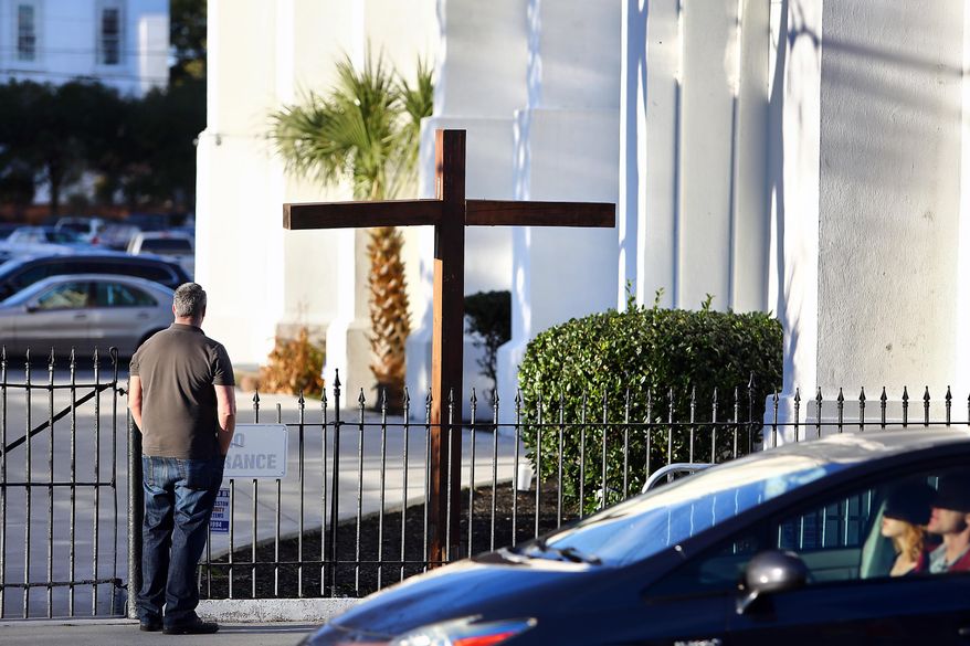 Bruce Chamberlin, on a visit from Washington, D.C., pays respects at Emanuel AME Church in Charleston, S.C., Wednesday, Jan. 11, 2017. One by one, family members of nine slain black parishioners confronted Dylann Roof for the last time Wednesday, shouting at him, offering forgiveness and even offering to visit him in prison as he awaits execution for the slaughter. (Wade Spees/The Post And Courier via AP)