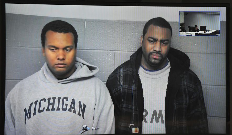FILE- in this file image from Oct. 27, 2015, taken from video provided by the 36th District Court, Detroit police officers Charles Lynem, 28, left, and Chancellor Searcy, 31, are arraigned via video conference in Detroit. Detroit Police Chief James Craig says the two members of an elite police unit can return to work after being acquitted of stealing money from people they stopped on the street. A jury acquitted Officers Lynem and Searcy on Jan. 11, 2017. They had been suspended without pay. (Wayne County District Court/Detroit News via AP)