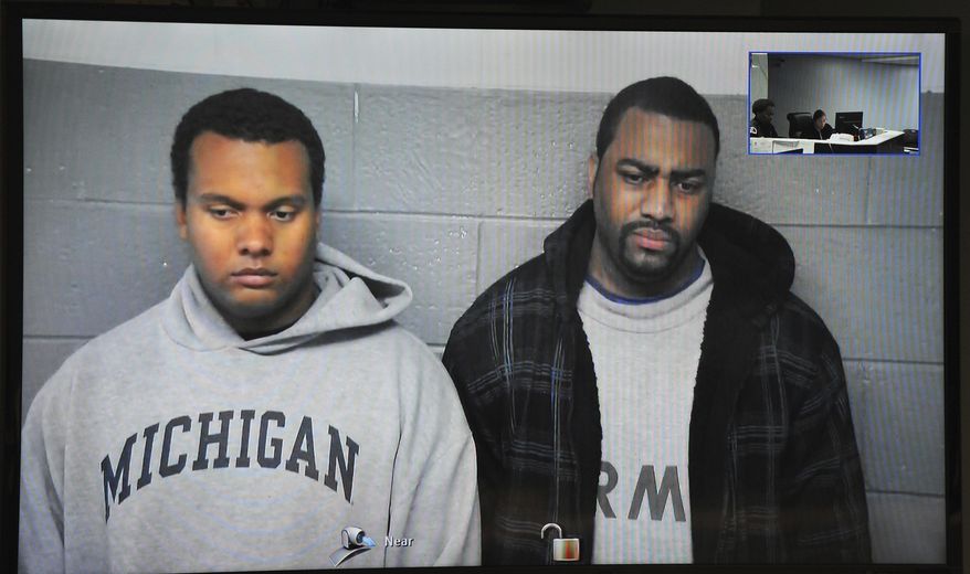 FILE- in this file image from Oct. 27, 2015, taken from video provided by the 36th District Court, Detroit police officers Charles Lynem, 28, left, and Chancellor Searcy, 31, are arraigned via video conference in Detroit. Detroit Police Chief James Craig says the two members of an elite police unit can return to work after being acquitted of stealing money from people they stopped on the street. A jury acquitted Officers Lynem and Searcy on Jan. 11, 2017. They had been suspended without pay. (Wayne County District Court/Detroit News via AP)