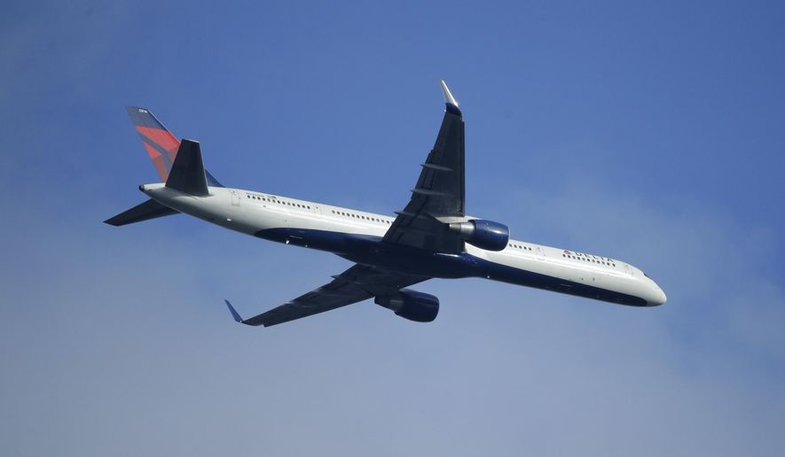 FILE - In this Sunday, March 6, 2016, file photo, a Delta Air Lines Boeing 757 flies overhead, in Seattle. On Thursday, Jan. 12, 2017, Delta Air Lines, Inc. reports financial results. (AP Photo/Ted S. Warren, File)