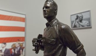 A maquette of Gerald R. Ford, left, is on display at the Gerald R. Ford Presidential Museum in Grand Rapids on Wednesday, Jan. 11, 2017. The maquette is a smaller version of a statue onboard the USS Gerald R. Ford supercarrier created by sculptor Brett Grill (Cory Morse/The Grand Rapids Press/MLive.com via AP)