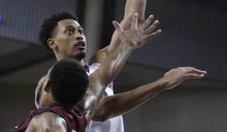 Gonzaga forward Johnathan Williams shoots while defended by Loyola Marymount forward Shamar Johnson during the first half of an NCAA college basketball game in Spokane, Wash., Thursday, Jan. 12, 2017. (AP Photo/Young Kwak)
