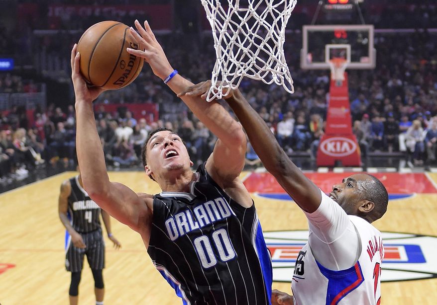 Orlando Magic forward Aaron Gordon, left, shoots as Los Angeles Clippers forward Luc Richard Mbah a Moute defends during the first half of an NBA basketball game, Wednesday, Jan. 11, 2017, in Los Angeles. (AP Photo/Mark J. Terrill)