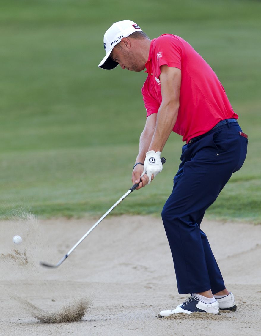 Justin Thomas hits his ball out of a green side bunker on the 10th green during the first round of the Sony Open golf tournament, Thursday, Jan. 12, 2017, in Honolulu. (AP Photo/Marco Garcia)