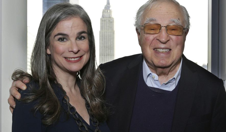 In this Jan. 6, 2017 photo, Arthur Former, 87, right, poses with his daughter, Pauline, in New York. It's been 60 years since the publication of Frommer's legendary travel guidebook, "Europe on $5 a Day." Frommer's message of authentic, bargain travel was revolutionary in its day, encouraging average people and not just the wealthy to travel. Today there are 101 Frommer's guidebooks to destinations around the world and a Frommers.com website. (AP Photo/Peter Morgan)