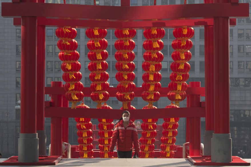 A woman walks up the steps decorated ahead of the Chinese New Year festival in Beijing, China, Thursday, Jan. 12, 2017. The Chinese Lunar New Year is the most important holiday for Chinese and hundreds of millions are expected to return to their hometown to spend the new year with their family and relatives. (AP Photo/Ng Han Guan)