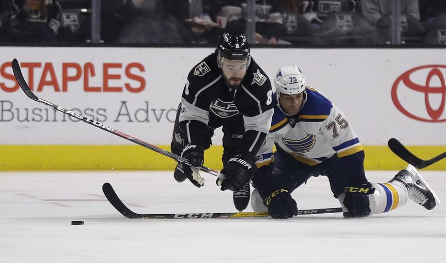 Los Angeles Kings defenseman Drew Doughty, left, vies for the puck with St. Louis Blues right wing Ryan Reaves during the first period of an NHL hockey game in Los Angeles, Thursday, Jan. 12, 2017. (AP Photo/Chris Carlson)