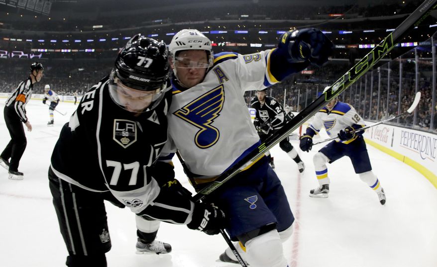 Los Angeles Kings center Jeff Carter, left, checks St. Louis Blues right wing Vladimir Tarasenko during the first period of an NHL hockey game in Los Angeles, Thursday, Jan. 12, 2017. (AP Photo/Chris Carlson)