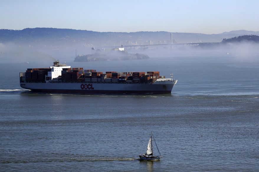 A sail boat and freight ship sail along the bay past Alcatraz Island and a fog covered city scape Friday, Jan. 13, 2017, in San Francisco. Sunshine and fog returned to some areas of Northern California after a series of storms which caused flooding in various cities. (AP Photo/Marcio Jose Sanchez)