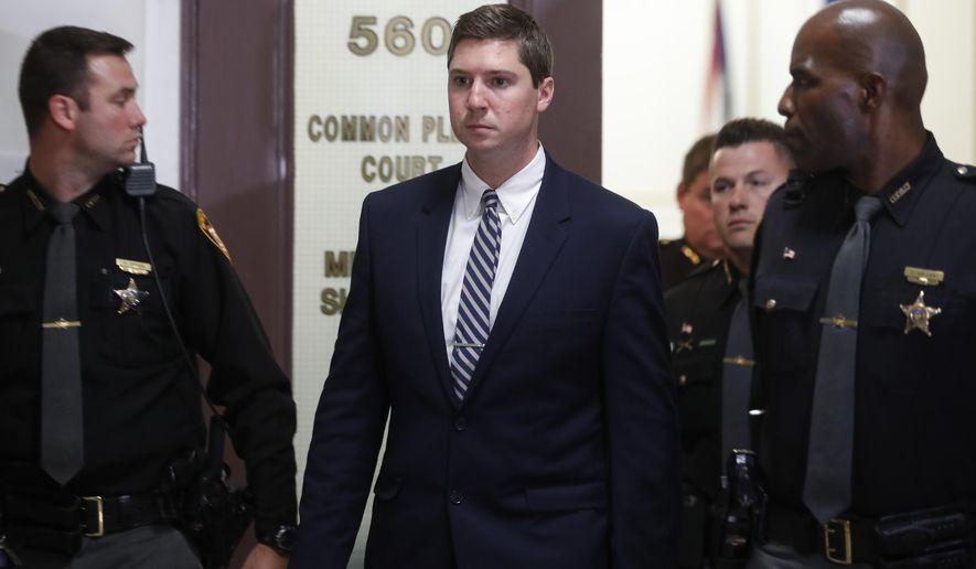FILE – In this Nov. 11, 2016, file photo, former University of Cincinnati police officer Ray Tensing, center, leaves court during jury deliberations in his murder trial in Cincinnati. Hamilton County, Ohio, Prosecutor Joe Deters announced Friday, Jan. 13, 2017, that he is removing himself from the murder case and will have a new prosecution team for Tensing's retrial. A jury deadlocked and a judge declared a mistrial Nov. 12, 2016, on charges of murder and voluntary manslaughter in the July 2015 shooting of unarmed black motorist Sam DuBose during a traffic stop. (AP Photo/John Minchillo, File)