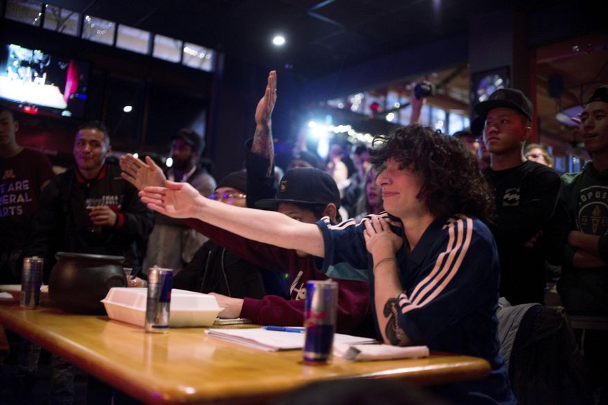 In this Dec. 4, 2016 photo, MonaLisa serves as one of three judges during a one-on-one breaking competition at Wild Tymes and the Palace Stage in St. Paul, Minn. Judges have different ways of judging, but MonaLisa uses a tally system that values uniqueness and innovation in battling. (Sam Harper/Minnesota Public Radio via AP)