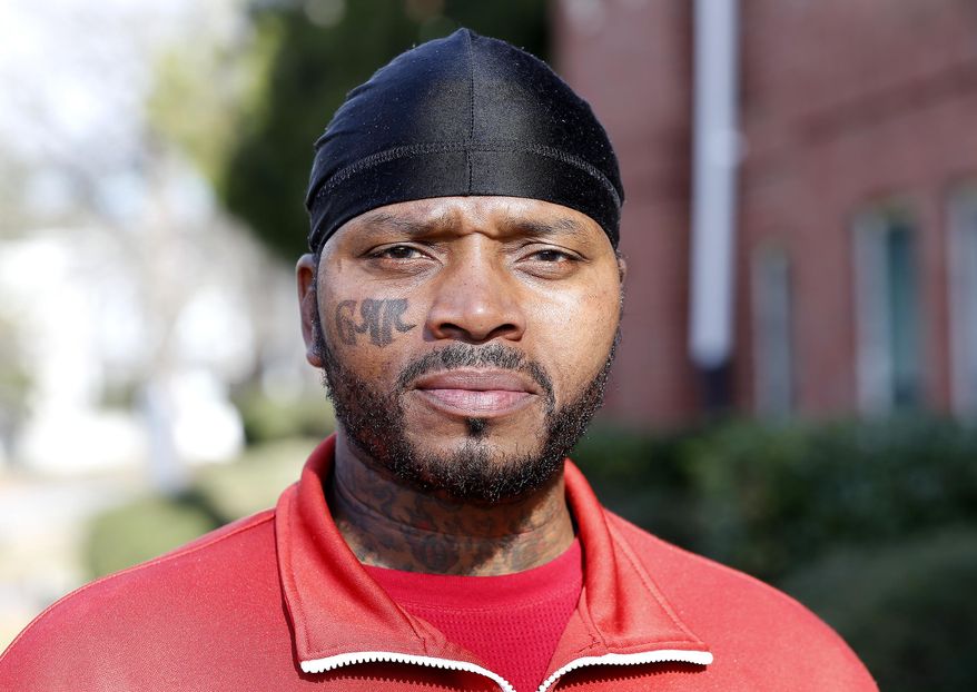 ADVANCE FOR USE SUNDAY, JAN. 15 - In this Dec. 14, 2016 photo, Charles Greene poses in Richmond Va. Greene said he intends to have more of his tattoos removed once he is finished with the process for the one on his cheek. (Mark Gormus/Richmond Times-Dispatch via AP)