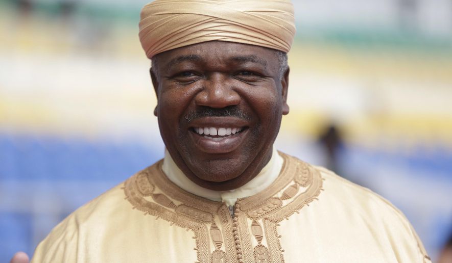 Gabon&#39;s President Ali Bongo Ondimba smiles as he visits workers at the Stade de l&#39;Amitie, ahead of the opening ceremony and group A soccer matches between Gabon and Guinea Bissau at the Africa Nations Cup in Libreville, Gabon, Friday, Jan. 13, 2017. (AP Photo/Sunday Alamba)