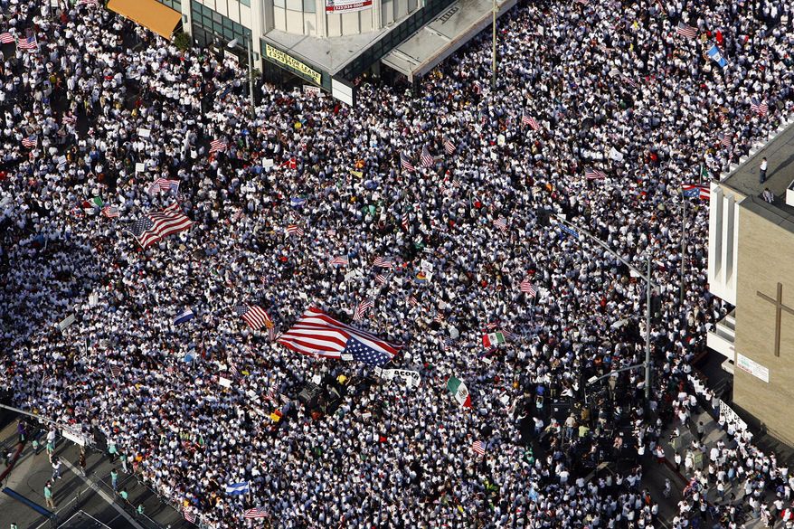 FILE - In this May 1, 2006, file photo, thousands of demonstrators march along Wilshire Boulevard during an immigration protest near MacArthur Park in Los Angeles. Immigrant rights advocates are planning demonstrations at dozens of rallies around the country this weekend in what they are calling “the first salvo” against President-elect Donald Trump’s pledged hard line on immigration. Union leaders and young immigrants are organizing more than 50 protests and cultural events from Philadelphia to Phoenix on Saturday, Jan. 14, 2017 with an aim toward highlighting the power of the immigrant rights movement. (AP Photo/Ric Francis, File)