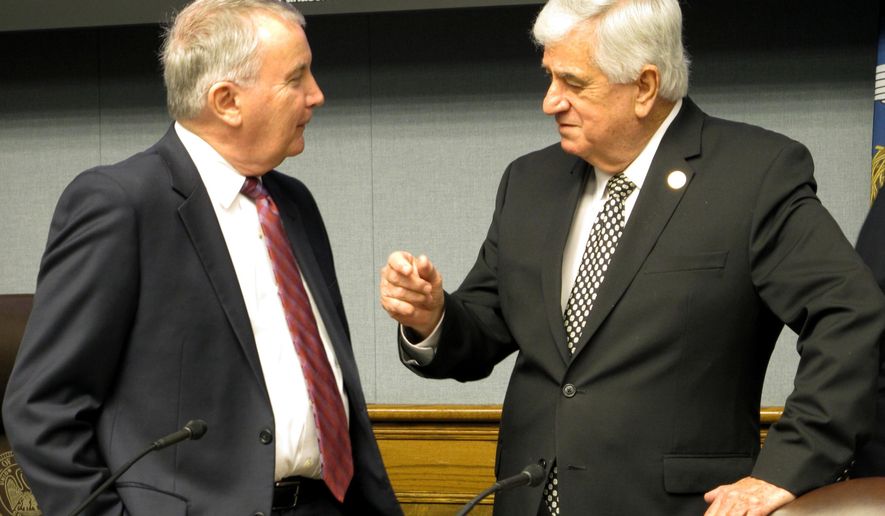 Louisiana State University economist Jim Richardson, left, and Senate President John Alario, R-Westwego, both members of Louisiana's revenue forecasting panel, speak ahead of a meeting to downgrade the state's income projections on Friday, Jan. 13, 2017, in Baton Rouge, La. After the panel's actions, the state has an estimated $313 million budget deficit. (AP Photo/Melinda Deslatte)