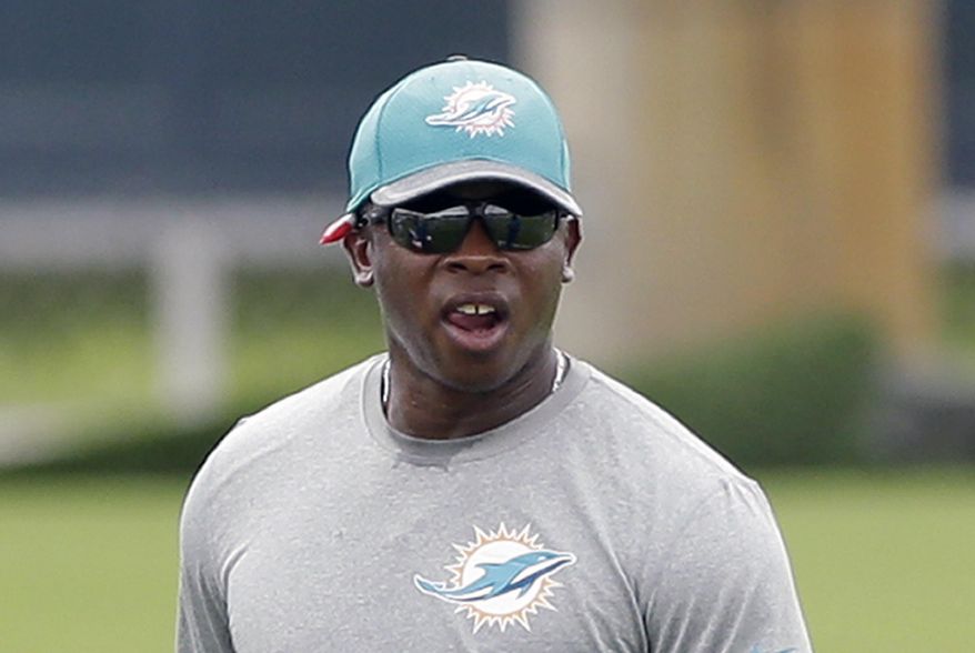 FILE - In this June 6, 2016, file photo, Miami Dolphins defensive coordinator Vance Joseph watches players during practice at the team's NFL football training facility in Davie, Fla. The NFL will have eight minority head coaches in 2017, tying the most for the beginning of one season.With the hirings of Anthony Lynn by the San Diego Chargers and Joseph by the Denver Broncos, the eight minority coaches will equal the number in 2011. (AP Photo/Alan Diaz, File)