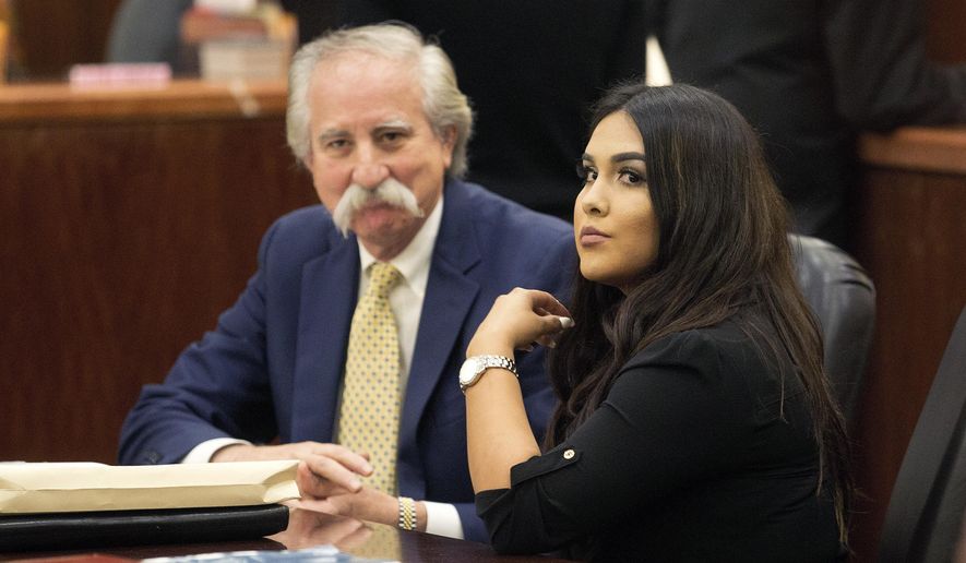 Alexandria Vera, a former Houston-area middle school teacher, sits with her attorney Ricardo Rodriguez as they wait for her hearing to begin, Friday, Jan. 13, 2017, in Houston. Vera, who pleaded guilty last year to having a long-term sexual relationship with a 13-year-old boy who impregnated her, was sentenced to 10 years in prison. (Bob Levey /Houston Chronicle via AP)