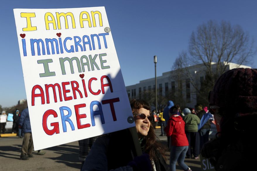Ellen Furstner, 62, of Marcola, carries a sign during an immigrant rights rally at the Oregon State Capitol in Salem, Ore., on Saturday, Jan. 14, 2017. She immigrated to the United States from Holland as a child.(Anna Reed /Statesman-Journal via AP)