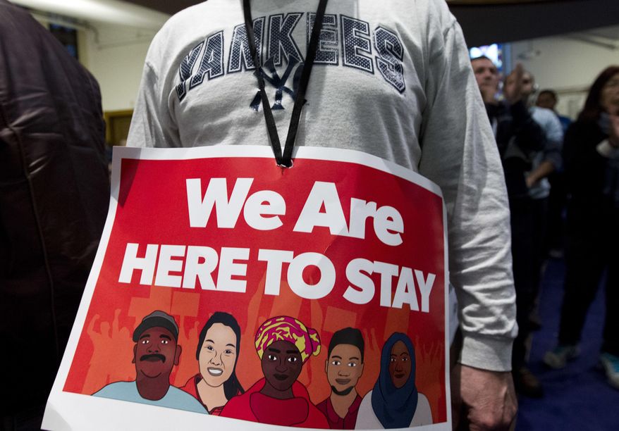 Immigrant rights advocates demonstrate against President-elect Donald Trump's immigration policies, during a rally at Metropolitan AME Church in Washington, Saturday, Jan. 14, 2017. ( AP Photo/Jose Luis Magana)