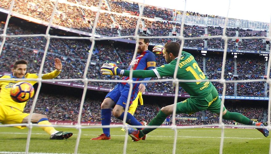 FC Barcelona's Lionel Messi, center, kicks the ball to score during the Spanish La Liga soccer match between FC Barcelona and Las Palmas at the Camp Nou in Barcelona, Spain, Saturday, Jan. 14, 2017. (AP Photo/Manu Fernandez)