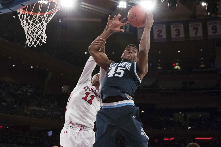 Villanova forward Darryl Reynolds (45) and St. John's forward Tariq Owensn vie for a rebound during the first half of an NCAA college basketball game, Saturday, Jan. 14, 2017, at Madison Square Garden in New York. (AP Photo/Mary Altaffer)