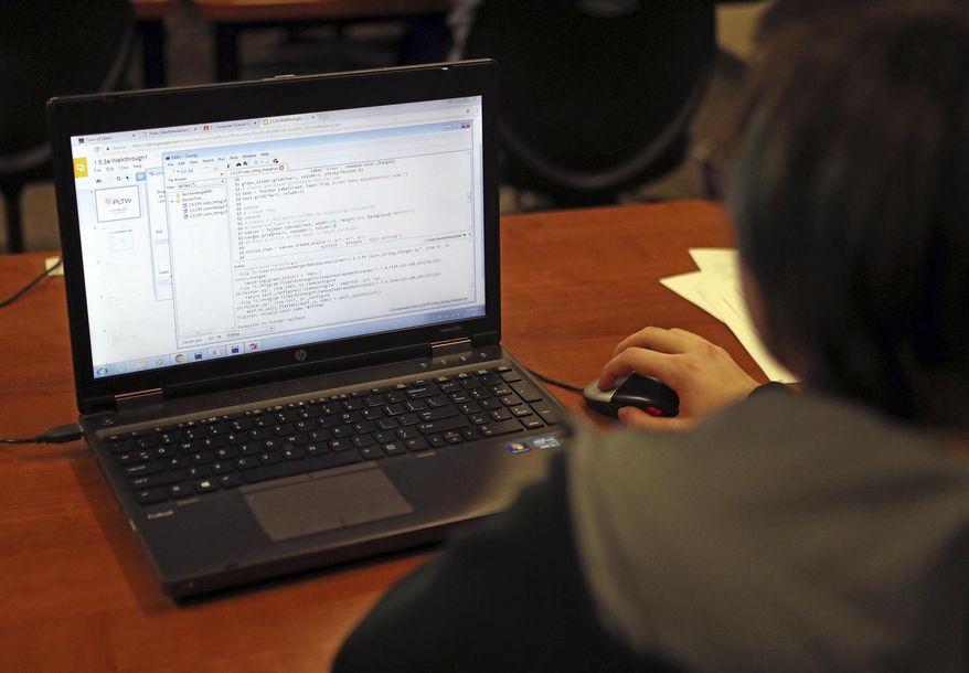 Thomas Jefferson High School senior Toby Lechtenberger modifies code to create a graphic user interface in science teacher Denise Hoag's classroom on Thursday, Jan. 6., 2017 in Council Bluffs, Iowa. Hoag are trying to get more girls interested in computer science, a traditionally male-dominated field. (Joe Shearer/The Daily Nonpareil via AP)