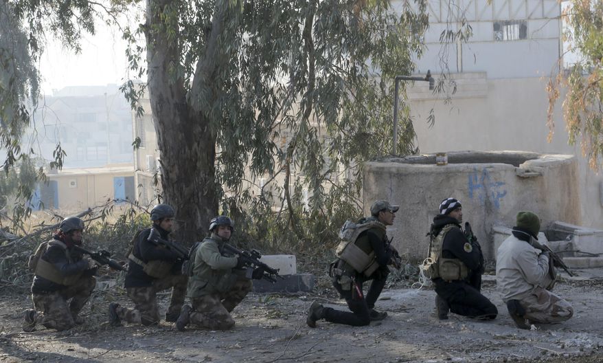 Iraqi special forces advance inside Mosul University grounds, during fighting against Islamic State militants in the eastern side of Mosul, Iraq, Saturday, Jan. 14, 2017. (AP Photo/ Khalid Mohammed)