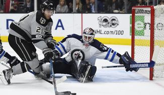 Los Angeles Kings center Nick Shore, left, tires to get a shot in on Winnipeg Jets goalie Michael Hutchinson during the second period of an NHL hockey game, Saturday, Jan. 14, 2017, in Los Angeles. (AP Photo/Mark J. Terrill)