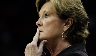 FILE - In this Nov. 12, 2010, file photo, Tennessee coach Pat Summitt watches her team against Louisville in an NCAA college basketball game in Louisville, Ky. For every home game during the fall 2016-17 basketball season, a chair of Tennessee’s bench is left vacant to honor former coach Summitt, who died June 28, 2016. But the Lady Vols aren’t the only team paying tribute to Summitt. Harvard, Vermont and Kentucky are among the Division I teams joining Tennessee in wearing commemorative patches to honor one of the game’s greatest ambassadors.  (AP Photo/Garry Jones, File)