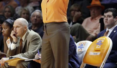 FILE - In this Dec. 4, 2016, file photo, Tennessee head coach Holly Warlick directs her players in a game against Baylor as she stands next to an orange chair labeled for Pat Summitt during an NCAA college basketball game against Baylor in Knoxville, Tenn. In addition to the chair, Tennessee players are wearing commemorative patches on their uniforms to honor Summitt, who died June 28. Other women&#39;s basketball programs without direct connections to Summitt also are finding ways to honor one of the game&#39;s greatest ambassadors in the season after her death. (AP Photo/Mark Humphrey, File)
