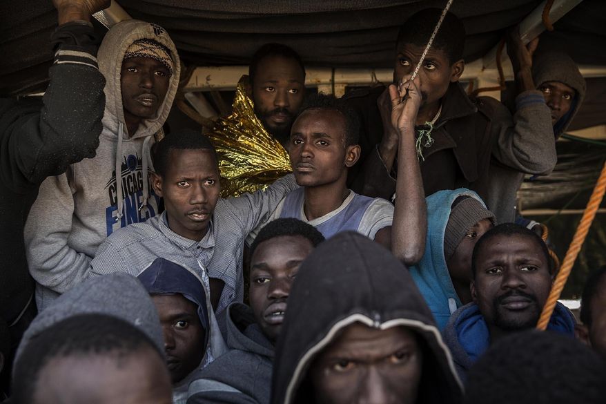 In this Saturday Jan. 14, 2017 photo, migrants from Mali crowd the deck of the Golfo Azzurro vessel after being rescued from the Mediterranean sea, about 20 miles north of Ra's Tajura, Libya. Spain's maritime rescue service says the bodies of seven African migrants have been found dead along the Strait of Gibraltar since Friday. (AP Photo/Olmo Calvo)